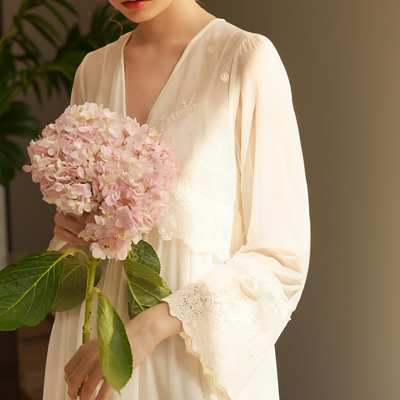 Close-up of lace embroidery and button detail on pink chiffon nightgown – Velourine Attire
