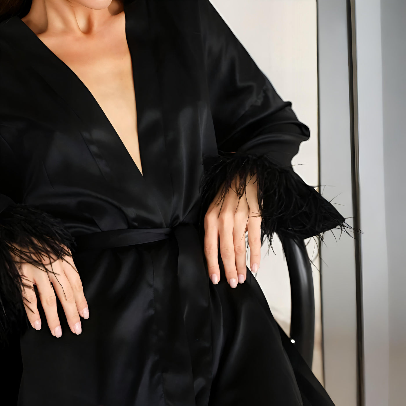 CLoser arm view Black satin robe with feather-trimmed sleeves and waist tie – Velourine Attire luxury bridal nightwear